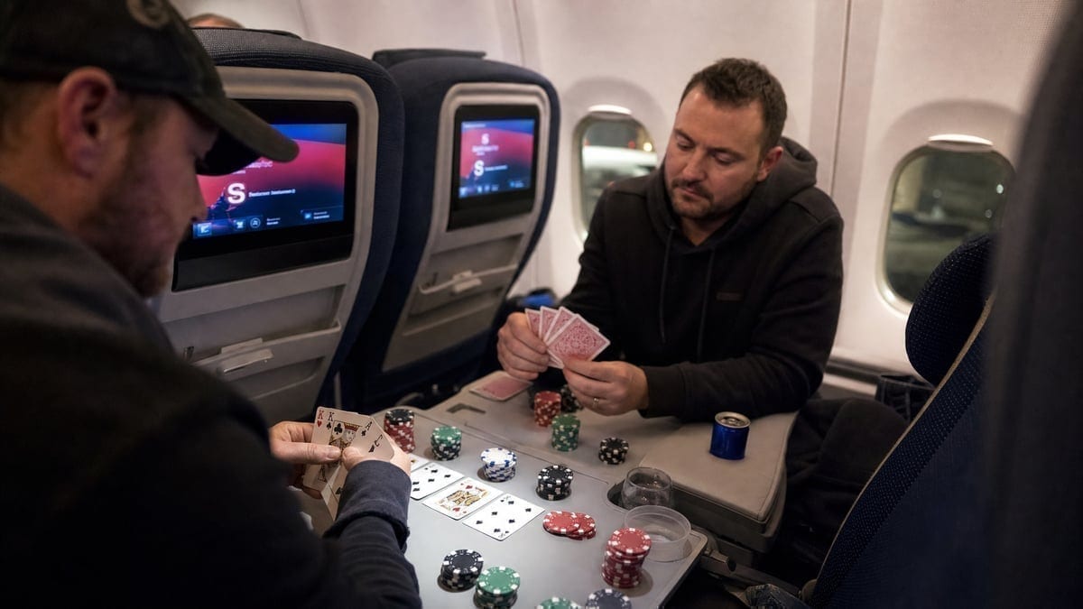 Poker game setup inside airplane cabin during flight